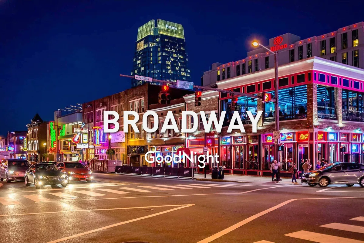 A lively Nashville street scene at night, featuring neon signs, bustling crowds, traffic lights, and illuminated buildings. The vibrant atmosphere captures the pulse of the city's nightlife and its famous music scene.