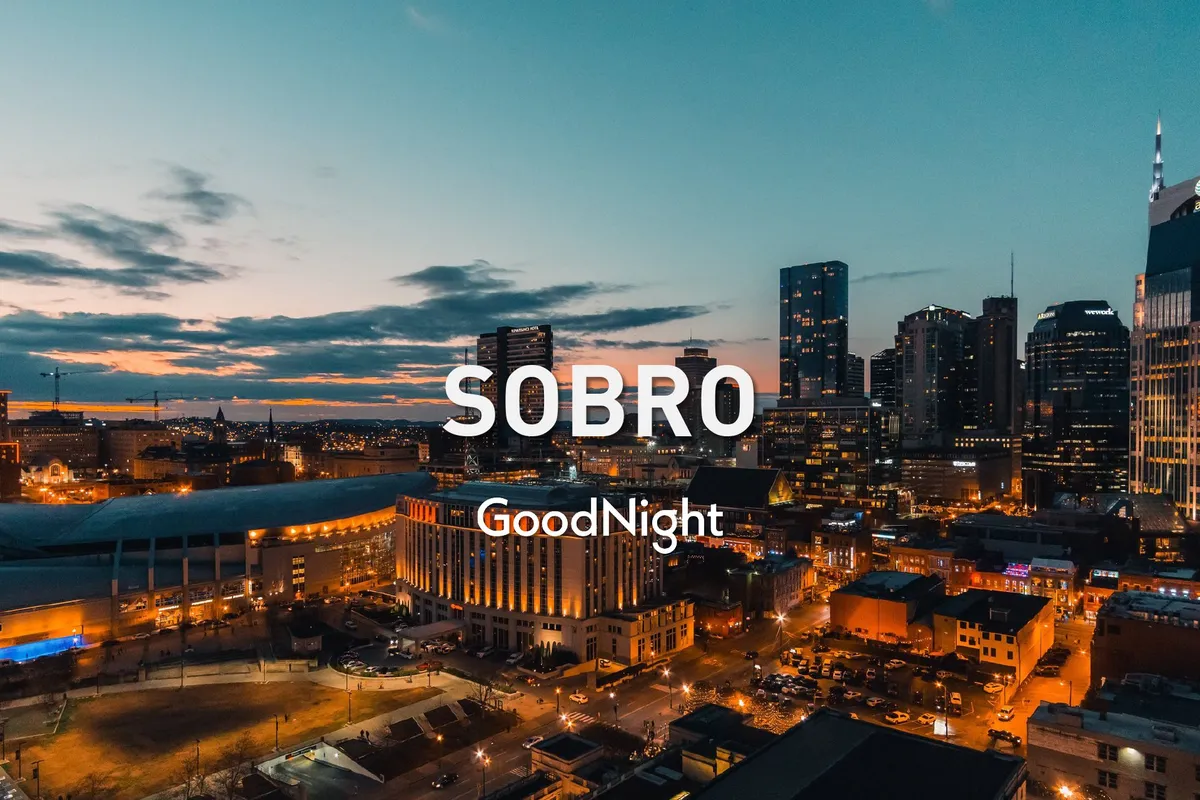 A sweeping evening view of the Nashville skyline at twilight, with prominent buildings lit up against a blue and purple sky. The scene exudes the allure of urban nightlife and city exploration.